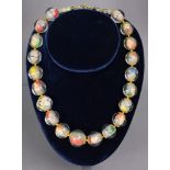 A Chinese necklace of twenty glass round beads with internal reverse-painted decoration of figures &
