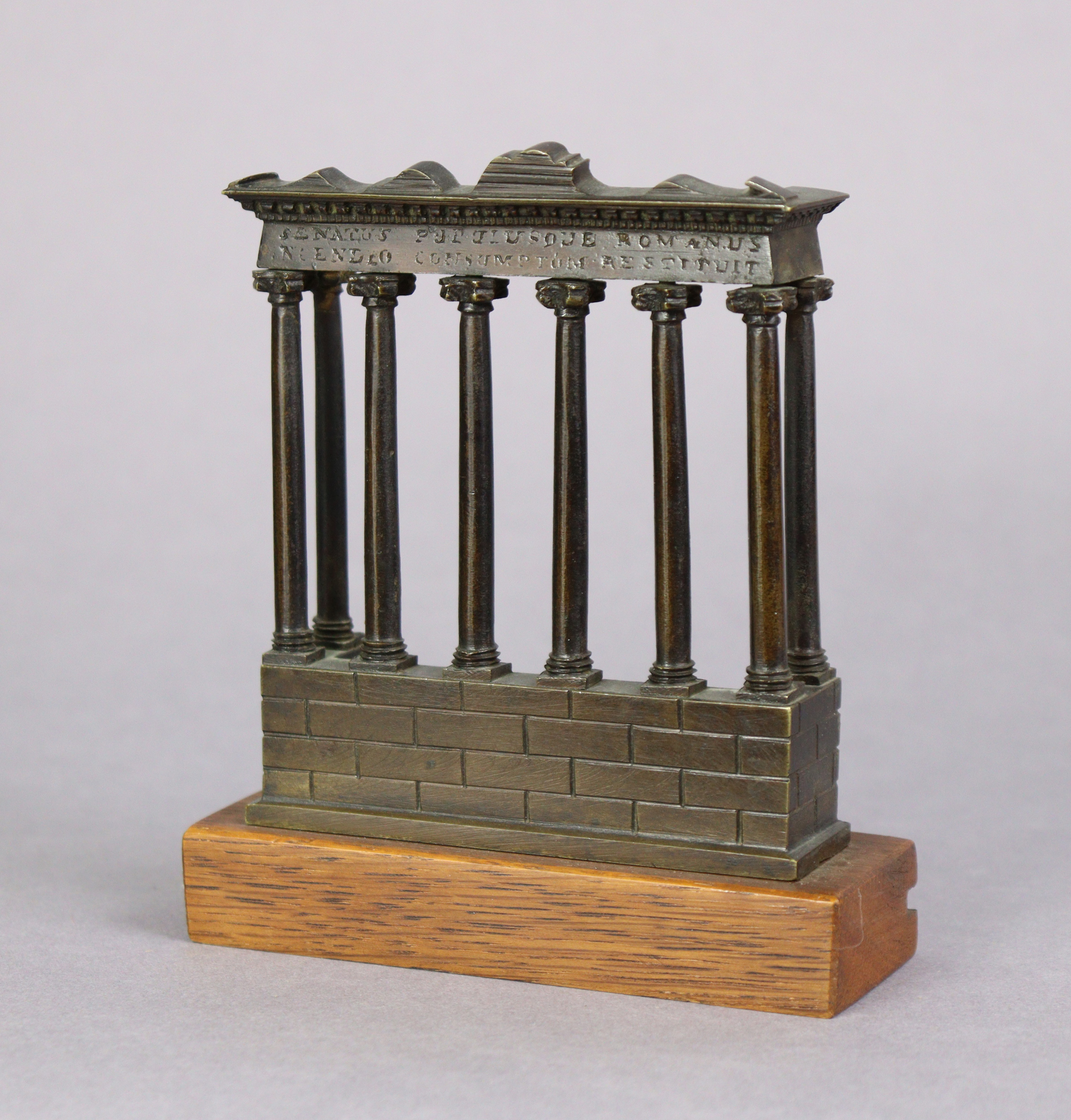 A 19th century Grand Tour bronze model of the Temple of Saturn, mounted on an oak plinth, 5¼” high x