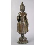 A 20th century Burmese bronze standing figure of Buddha with right hand raised, on circular double-