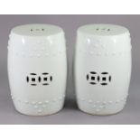 A pair of Chinese white-glazed porcelain garden seats, of barrel form with pierced sides, each