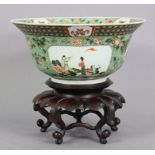 An 18th/19th century famille verte porcelain bowl, of ‘Klapmuts’ shape, painted with figure scenes &