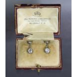 A pair of diamond drop earrings, each with collet-set slightly irregular round-cut stone of