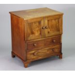 A Victorian mahogany chest commode with a plain rectangular hinged top above pair of faux panel