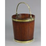 A GEORGE III MAHOGANY & BRASS BOUND PEAT BUCKET, of coopered tapering form, the overhang handle with