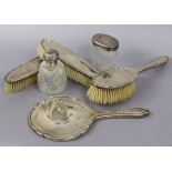 A George V silver four-piece dressing table set with engraved floral decoration & initials “ADH”,