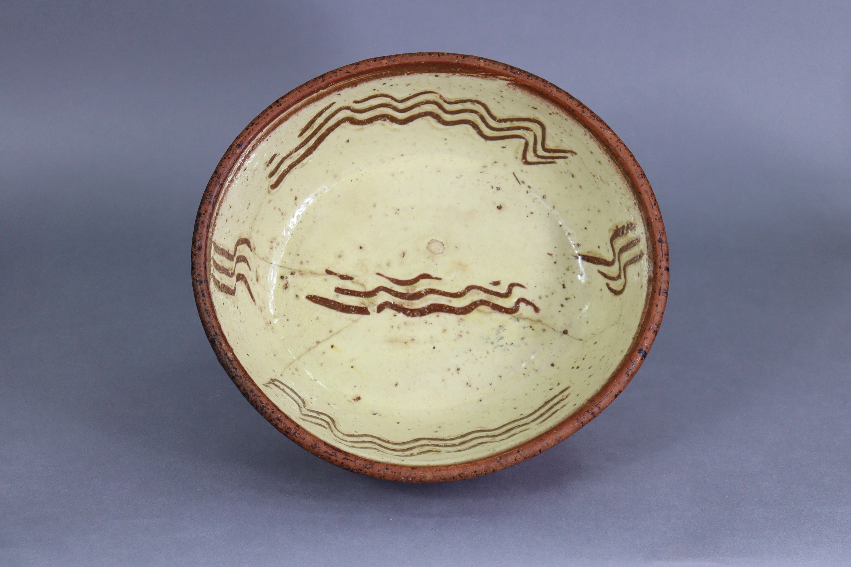 A 19th century English slipware oval baking dish, the cream-glazed interior with sgraffito - Image 2 of 3