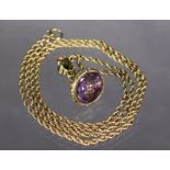 A yellow metal fob seal with amethyst matrix, on a 9ct. gold rope-twist chain, 63cm long. (the