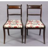 A pair of Regency mahogany dining chairs with rope-twist centre rails to the reeded bow-backs,