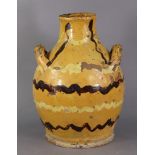 A 19th century English slipware two-handled vase of baluster shape, with squiggled decoration in