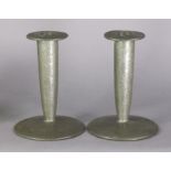 A pair of Liberty & Co. “Tudric” pewter candlesticks, each with planished surface, tapered