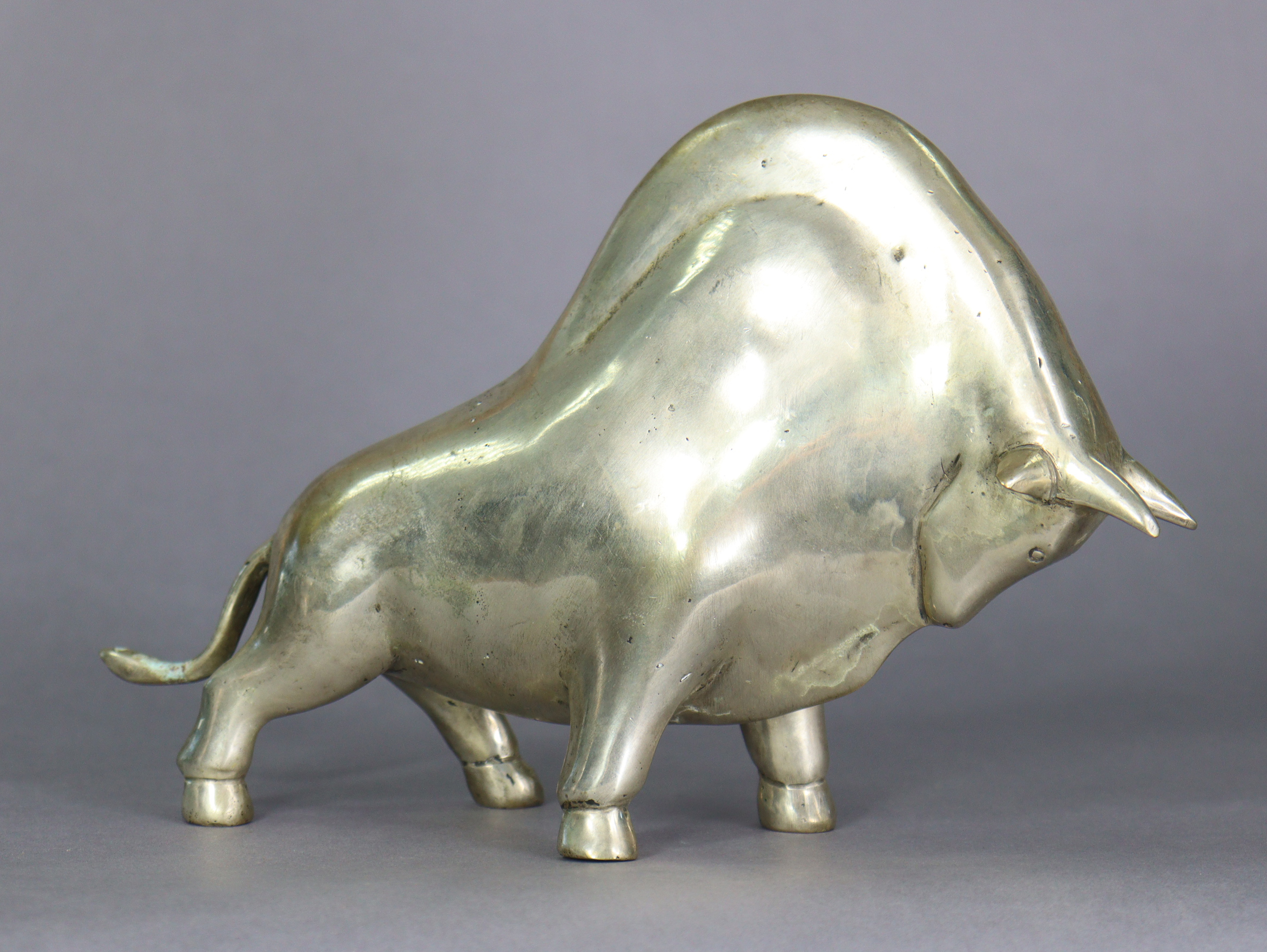 A Modernist silvered-metal sculpture of a bull, inscribed initials P. J. & numbered1/4 to underside