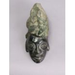 A Brazilian carved green granite head with polished face, 7” high x 2¾” wide x 4” deep.
