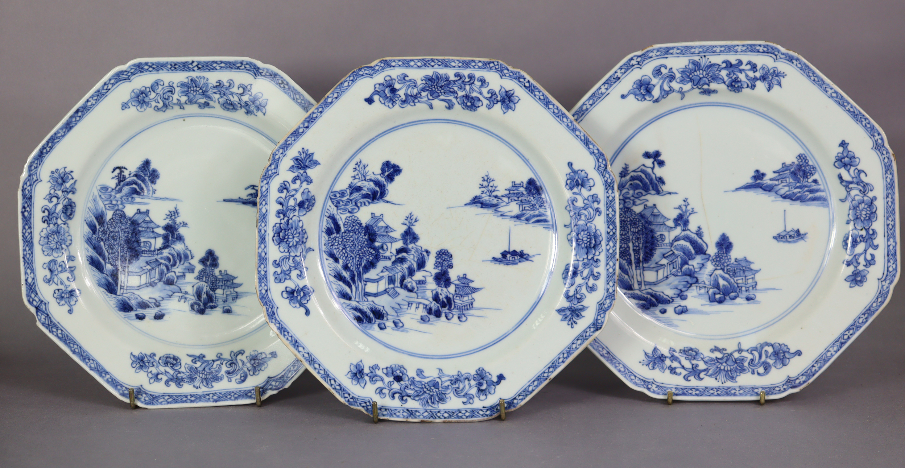 A set of three 18th century Chinese blue & white porcelain octagonal plates, each with a river