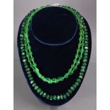 Two necklaces of translucent green quartz oval beads with small yellow jade spacers, 44 & 43 cm