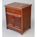 A Chinese teak small cabinet fitted frieze drawer above cupboard enclosed by a pair of panel