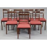 A set of eight regency-style mahogany bow-back dining chairs each with a padded seat, & on sabre