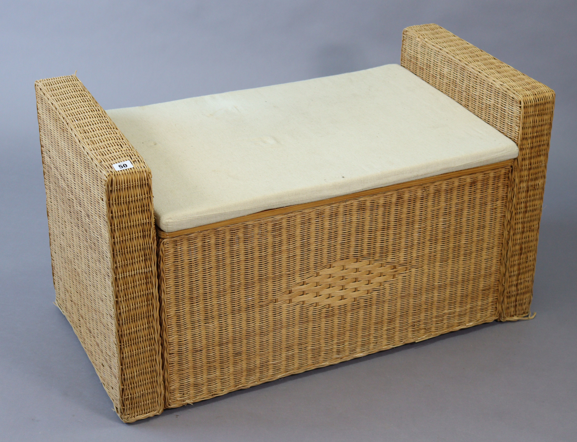 A wicker blanket box with a padded seat, 37” wide x 21” high.