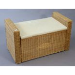 A wicker blanket box with a padded seat, 37” wide x 21” high.