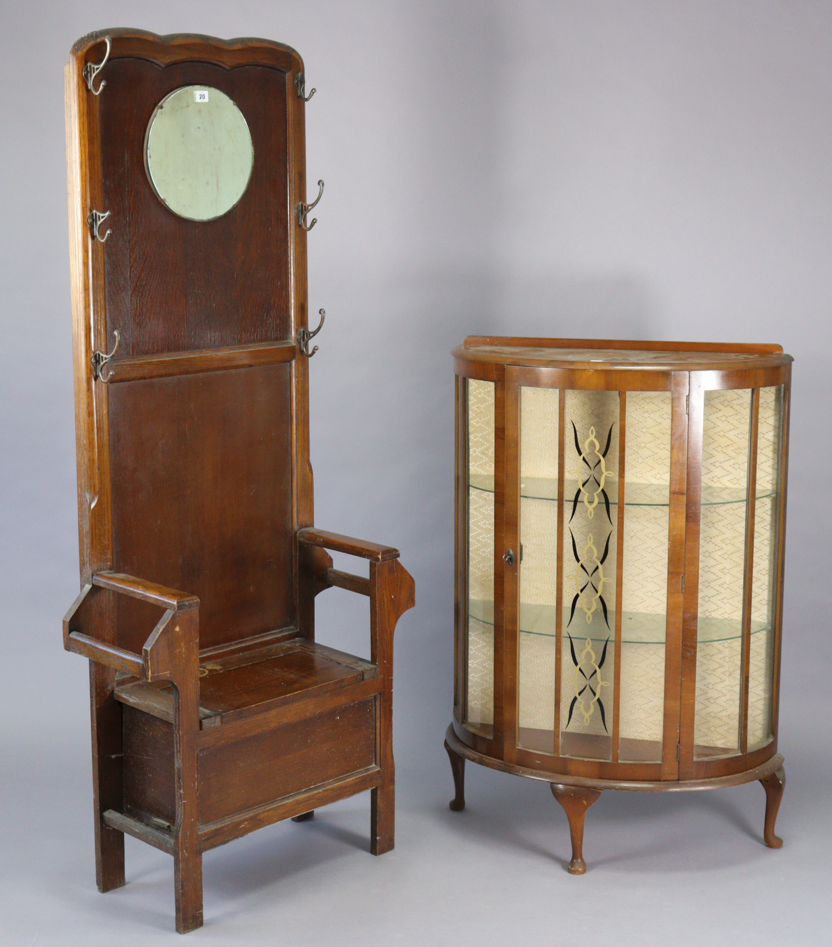 A mid-20th century oak hallstand inset circular mirror to the top, with a boxed hinged seat, & on