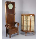 A mid-20th century oak hallstand inset circular mirror to the top, with a boxed hinged seat, & on