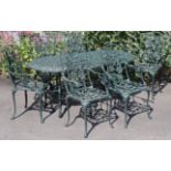 A Victorian-style green painted aluminium garden table with a pierced foliate rectangular top & on