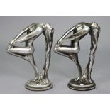 A pair of Art Deco-style silvered-finish composition standing nude female figures, 21¾” high.