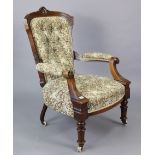 A Victorian carved beech-frame buttoned-back easy chair upholstered multi-coloured floral