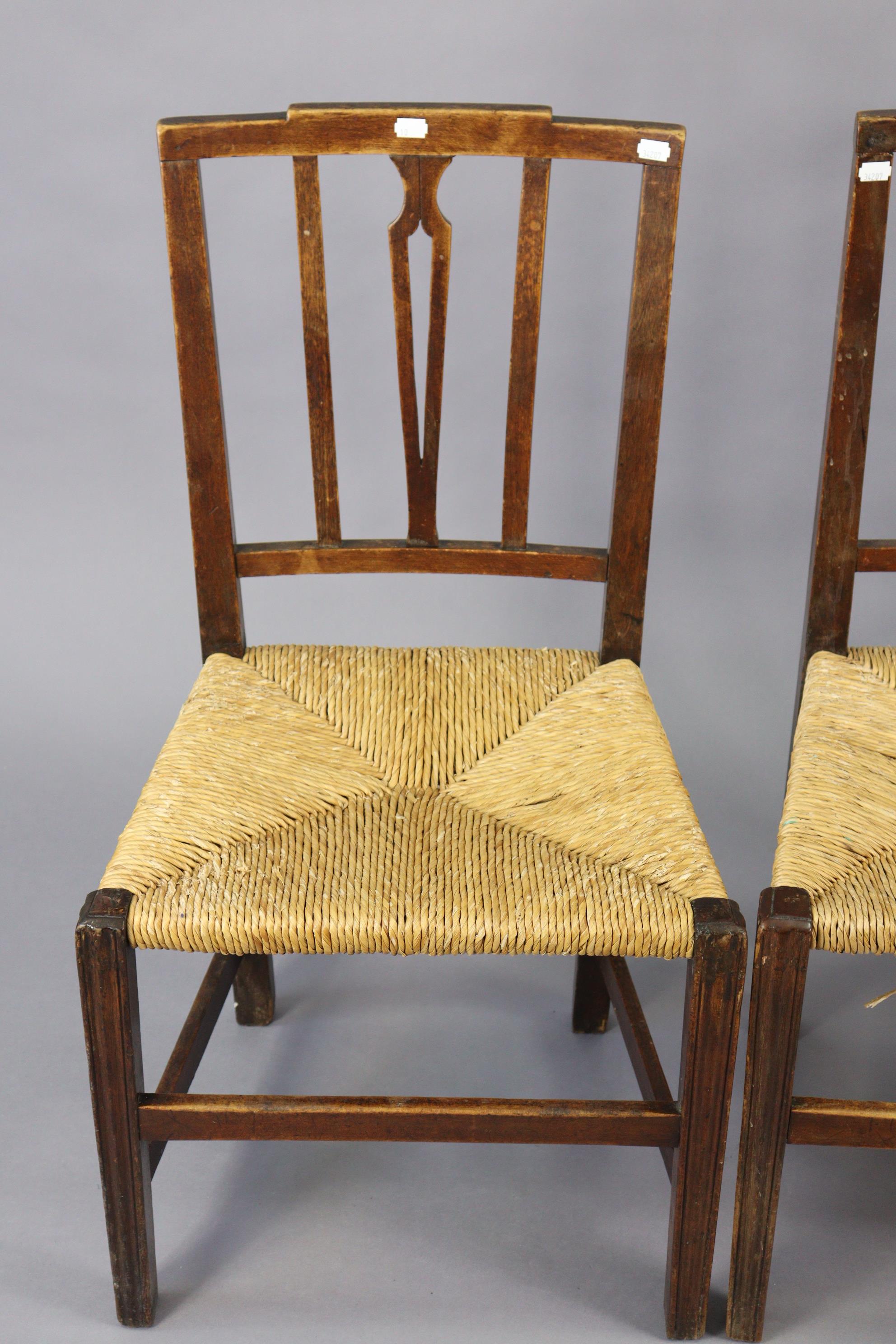 A set of three early 20th century splat-back dining chairs each with a woven-rush seat, & on - Image 4 of 10