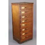 An early 20th century pine & plywood upright office cabinet fitted eight drawers with black