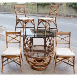 An Angraves of Thumaston bamboo conservatory dining table having a smoked-glass oval top, 65” wide x