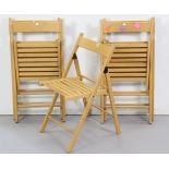 A set of five beech fold-away kitchen chairs.