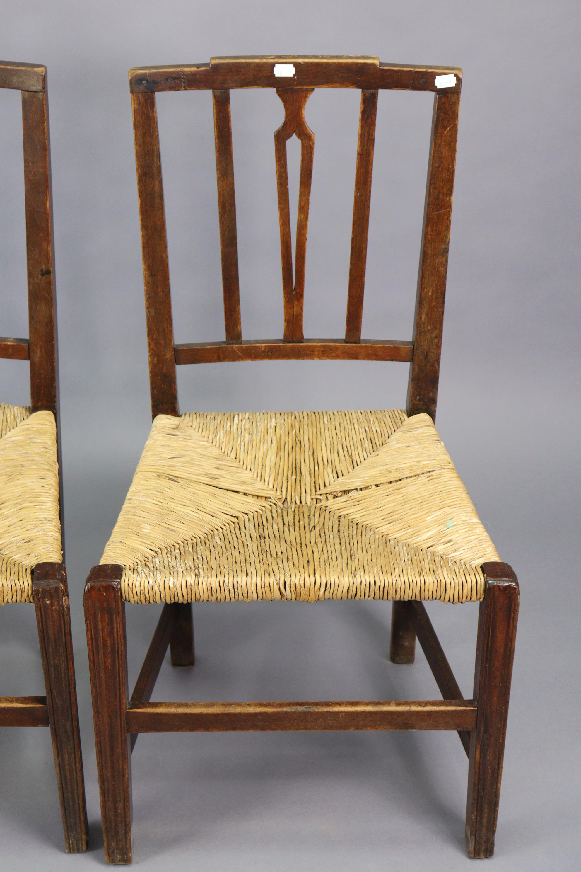 A set of three early 20th century splat-back dining chairs each with a woven-rush seat, & on - Image 3 of 10