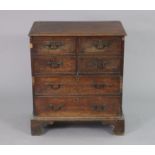 An 18th century-style oak chest commode with moulded edge to the hinged lift top, fitted swan-neck
