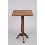 A late Georgian mahogany tripod table with rectangular tilt-top, on a vase-turned centre column &