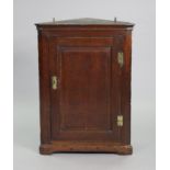 *Withdrawn* An 18th century oak corner cupboard, fitted three shelves enclosed by a fielded pan