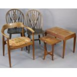 A teak elbow chair with a padded seat, & on round tapered legs; together with a pair of wheel-back