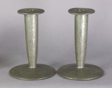 A pair of Liberty & Co. “Tudric” pewter candlesticks, each with planished surface, tapered