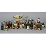 Thirty-two various spirit miniatures, most with contents; a “Guinness” advertising figure; two