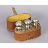 A set of three Edwardian glass travelling flasks each with a silver screw-on top, Birmingham 1901; &
