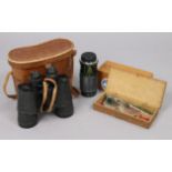 A pair of TS black lacquered 7 x 50mm field glasses, with case; a Hoy 52mm camera lens; & a set of