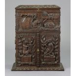 AN ANTIQUE CARVED OAK BLACK FOREST PIPE-SMOKERS CABINET WITH ALL-OVER ANIMAL AND FOLIAGE DECORATION,