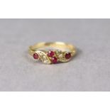 An 18ct. gold dress ring set four simulated rubies & four simulated diamonds, 2.1g.