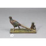 A cold painted spelter novelty match-striker in the form of a standing pheasant on a rectangular
