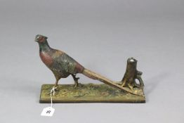 A cold painted spelter novelty match-striker in the form of a standing pheasant on a rectangular
