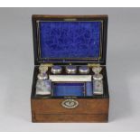 A Victorian burr-walnut, mother-of-pearl inlaid vanity box fitted with nine glass receptacles, eight