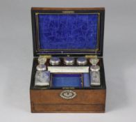 A Victorian burr-walnut, mother-of-pearl inlaid vanity box fitted with nine glass receptacles, eight