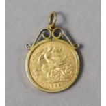 An Edwardian gold half-sovereign, 1910, loose-set in 9ct gold pendant mount.