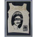An A & M Records “Sex Pistols, God Save The Queen” t-shirt, in a glazed frame, 27¼” x 19¼”.