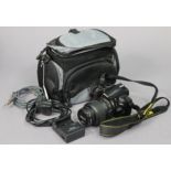 A Nikon “D300” camera with case.