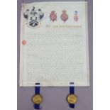 A Victorian Grant-Of-Arms, the parchment scroll illuminated with armorial & crests to the upper